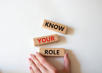 Know your role symbol. Wooden blocks with words Know your role. Beautiful white background. Businessman hand. Business and Know your role concept. Copy space.