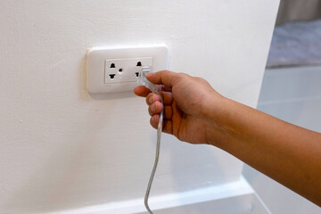 Hand insert a plug into socket.