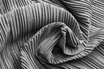 Background of grey textile pleats. Wrinkled fabric as background texture