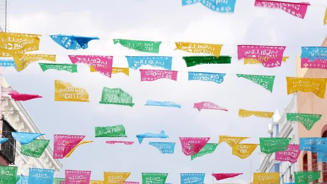 Colorful mexican perforated papel picado banner, festival colourful paper garland. Multi colored hispanic folk carved tissue flags, holiday or carnival. Authentic fiesta decoration in Latin America.