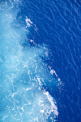 Bright blue ocean water wake from cruise ship