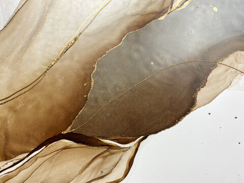 Abstract brown art with gold and gray &mdash; beige background with golden paint. Beautiful smudges and stains made with alcohol ink. Brown fluid art texture resembles brown marble, watercolor or aquarelle.
