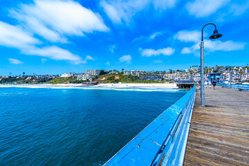 View of San Clemente beach and beachfront housing from the middle of the San Clemente Pier in Southern California