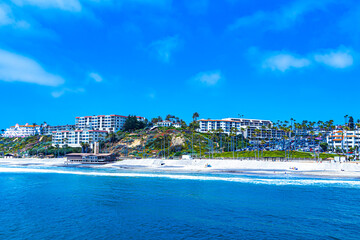 View of San Clemente beach and beachfront housing from the Pacific Ocean off the shore of San Clemente in Southern California