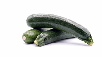 close up of a group of beautiful zucchinis on a white background