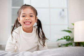 Happy Little Asian girl child with a big smile and laughing Healthy happy funny smiling face young adorable lovely female kid.Joyful portrait of Asian elementary school students.
