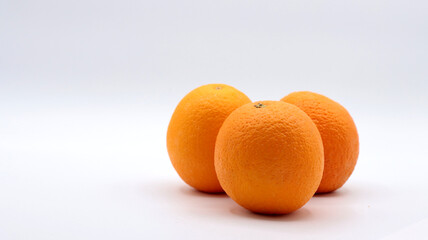 close up of a group of oranges on a white background