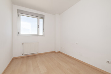 An empty room in an apartment with an aluminum and glass window