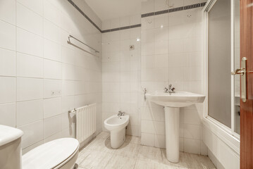 Naklejka na ściany i meble A full bathroom with showers with screens, white porcelain toilets