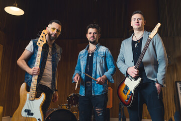 Obraz premium Young musicians practising the song in rehearsal room. High quality photo