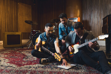 Young musicians practising the song in rehearsal room. High quality photo