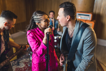 Young musicians practising the song in rehearsal room. High quality photo
