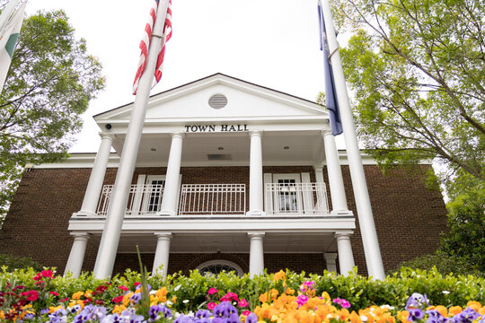 Summerville, South Carolina town hall in downtown Summerville. Summerville is the birth place of sweet tea and has lots of southern charm. American flag, South Carolina state flag, and city flag fly.