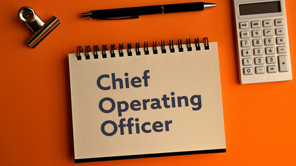 There is notebook with the word Chief Operating Officer. It is as an eye-catching image.