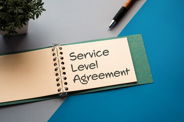 There is notebook with the word Service Level Agreement.It is as an eye-catching image.