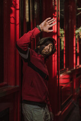 Male Asian model with red clothes posing for photographs