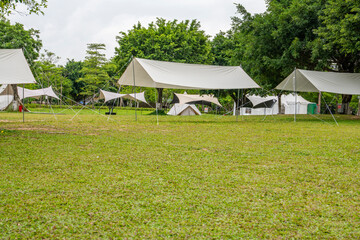 Fototapeta premium Camping tents on green grass in the park