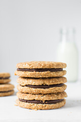 oat cookies with chocolate filling, homemade oatmeal cookies filled with chocolate ganache, thin oat biscuits with chocolate ganache