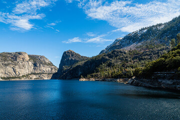 Yosemite National Park, CA, USA - March 7, 2022:  Hetch Hetchy Lake, dam, waterfalls, peaks  and rock formations.