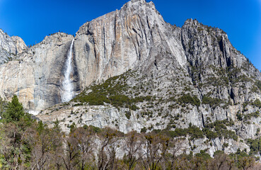 Fototapeta na wymiar Yosemite NP, CA, USA - March 29, 2022: Majestic views of granite formations, waterfalls, lakes and streams located within this popular destination.