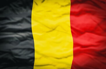 Fototapeta premium Belgium flag on a fabric wavy background. Wavy flag of Belgium fills the frame.