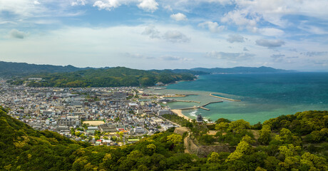 Fototapeta premium Panoramic aerial view of Sumoto Castle and small town in coastal landscape