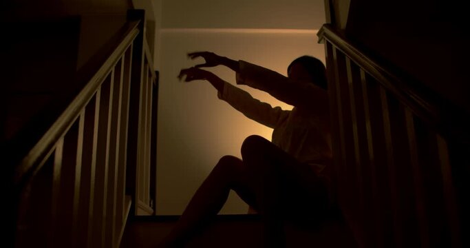 A lonely woman is sitting on the stairs at night . This concept use for symptoms of stress, major depressive disorder (MDD), psychotic symptoms.

