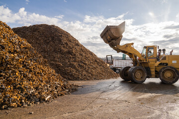 excavator machinery  working in scrap yard recycling metal  plant