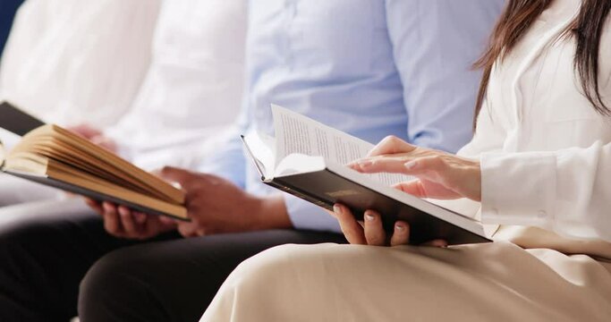 People Sitting In A Row Reading