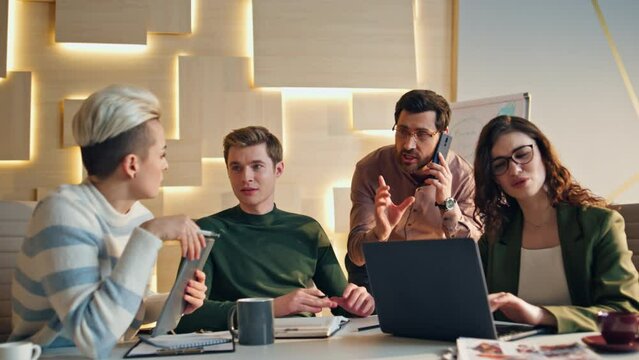 Busy team working workplace solving business issues together. Business people