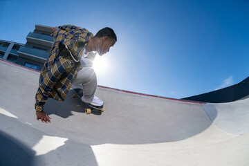 Surf skater performing a slide on a skatepark © homydesign