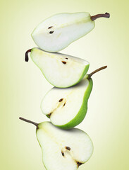 Cut fresh ripe pears on green yellow background
