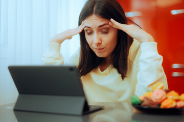 Stressed Woman Suffering a Migraine Trying to Work. Unhappy online remote worker trying to meet the...