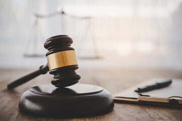 Law theme, mallet of the judge, law enforcement officers, evidence-based cases and documents taken...