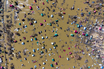 View from a high altitude of flooded houses in the countryside during the spring flood