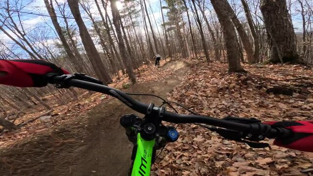 mtb riders action packed trail with jumps and tight berms pov autumn