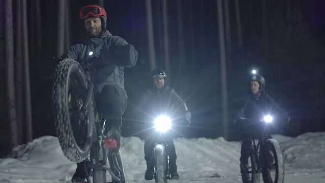 fatbike guy doing wheelie at night