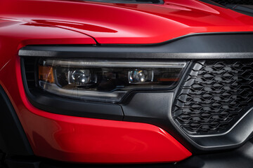 Red car headlights. Exterior detail. Close up detail on one of the LED headlights modern car..