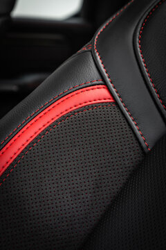 close-up black and red  perforated leather car seat. Skin texture