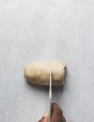 dough being divided into portions, process of making Swedish cinnamon buns or homemade Kanelbullar
