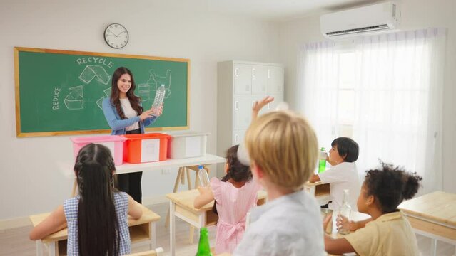 Group of student learn with teacher in classroom at elementary school. 