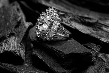 Silver ring on black charcoal, closeup