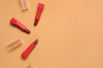 Red lipsticks on beige background