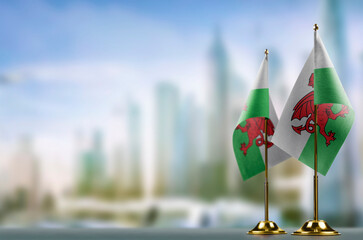 Small flags of the Wales on an abstract blurry background