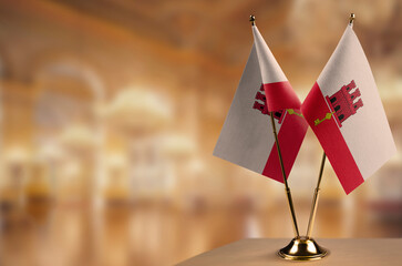 Small flags of the Gibraltar on an abstract blurry background
