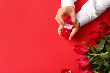 Man with engagement ring and roses on red background