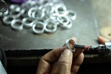 Close-up of craftsman hand making ring made of silver Folk handicrafts of Nan Province, Thailand