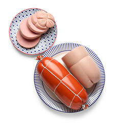 Plates with tasty boiled sausages on white background