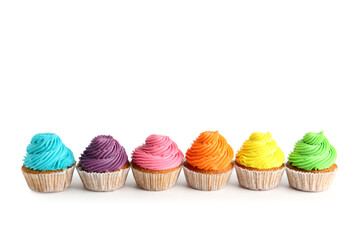 Tasty colorful cupcakes on white background