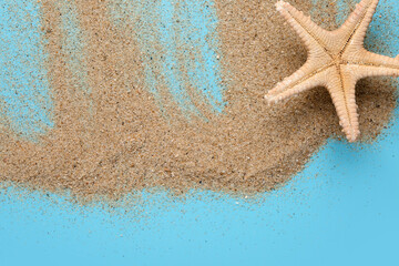 Fototapeta na wymiar Sand and starfish on blue background